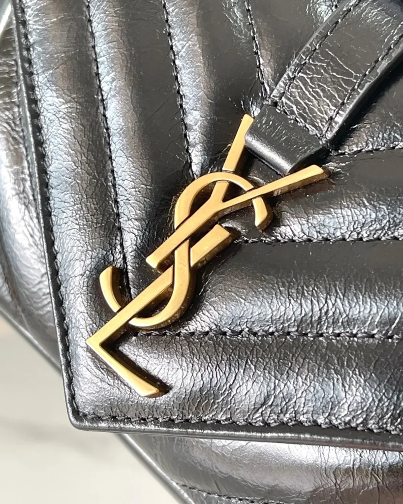 Black Chevron Top-Handle Flap Bag — logo detail view