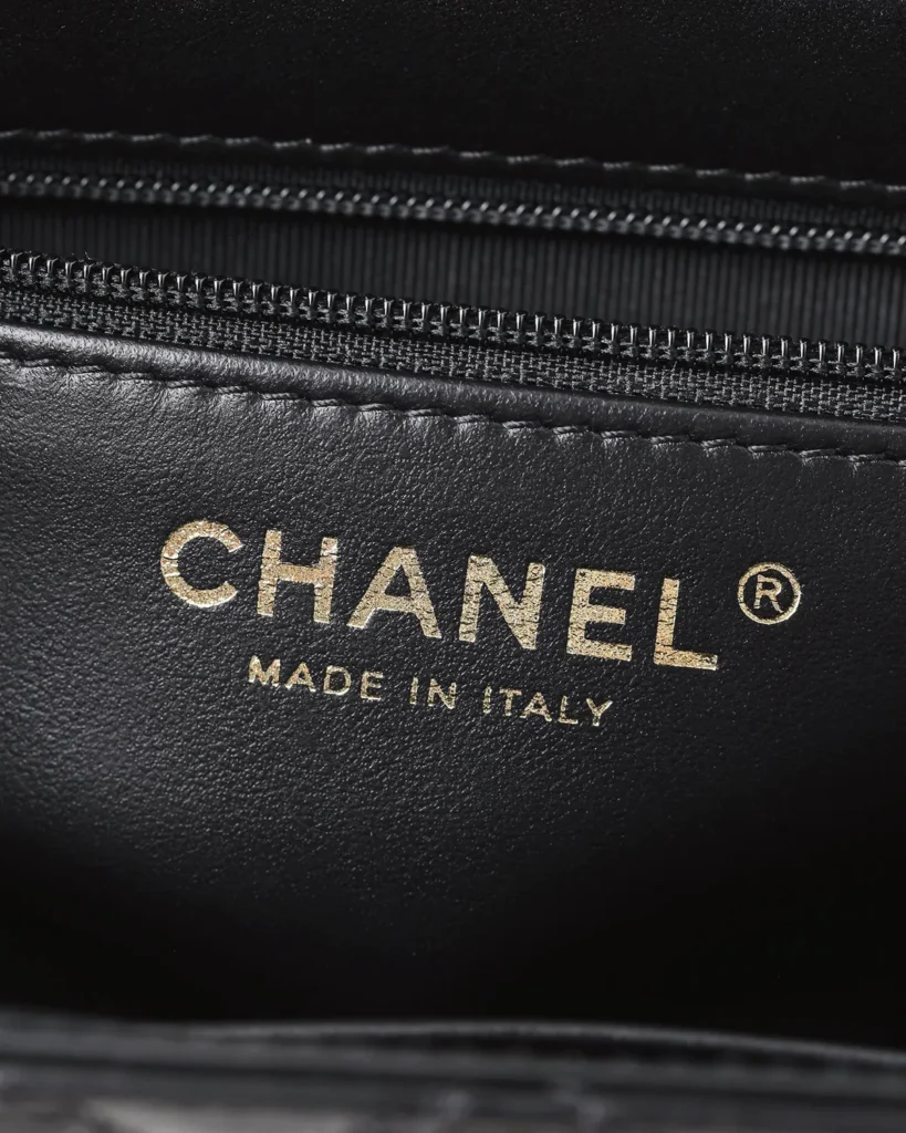 Black Quilted Tab-Flap Top-Handle Bag — interior label view