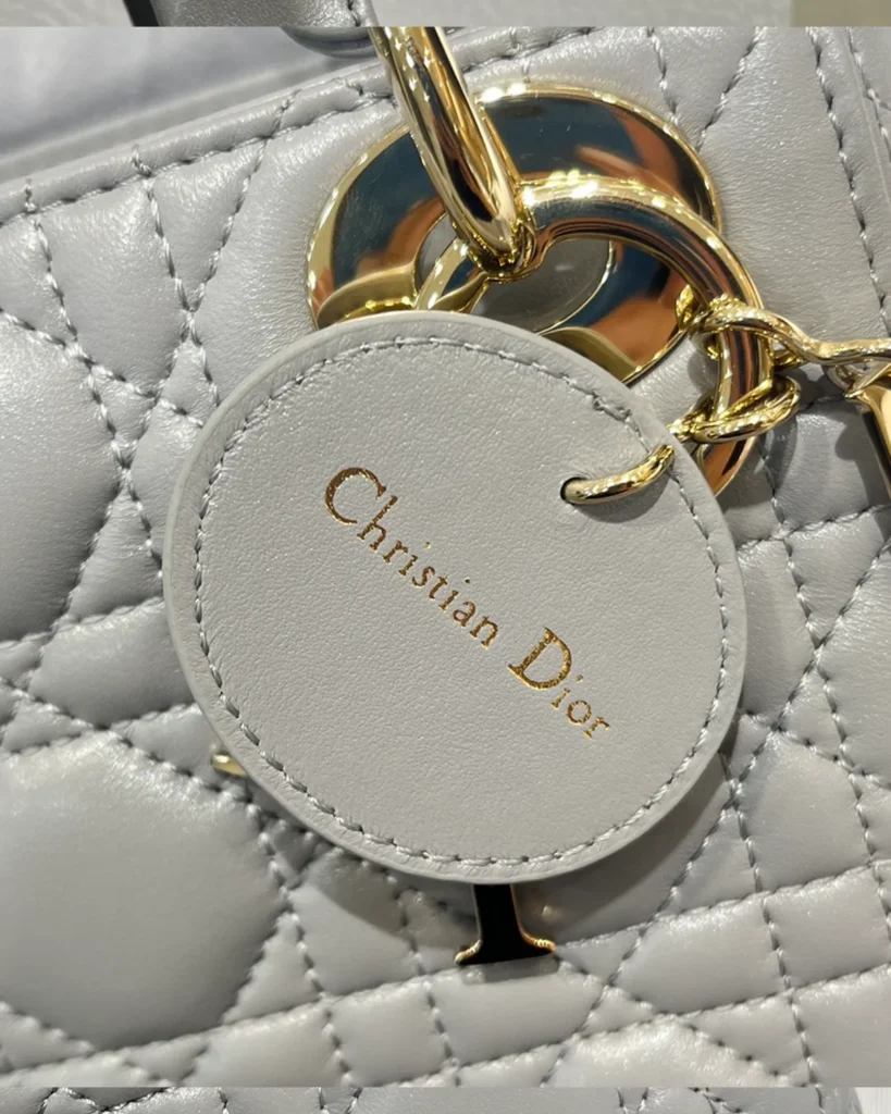 Pearlescent Gray Quilted Top Handle Bag — tag detail view