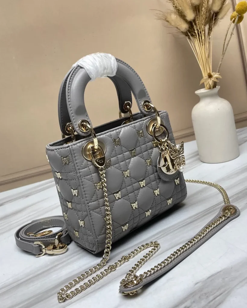 Gray Butterfly Stud Quilted Top Handle Bag — angled front view