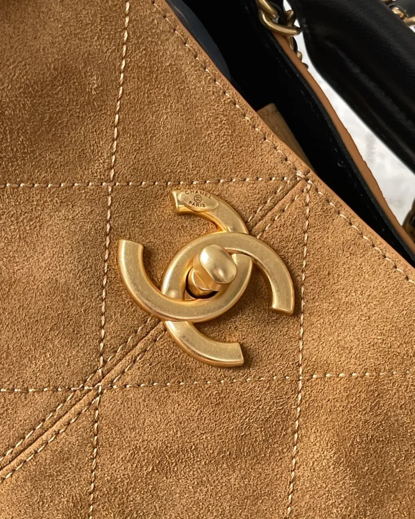 Tan and Black Quilted Chain Tote — logo detail view