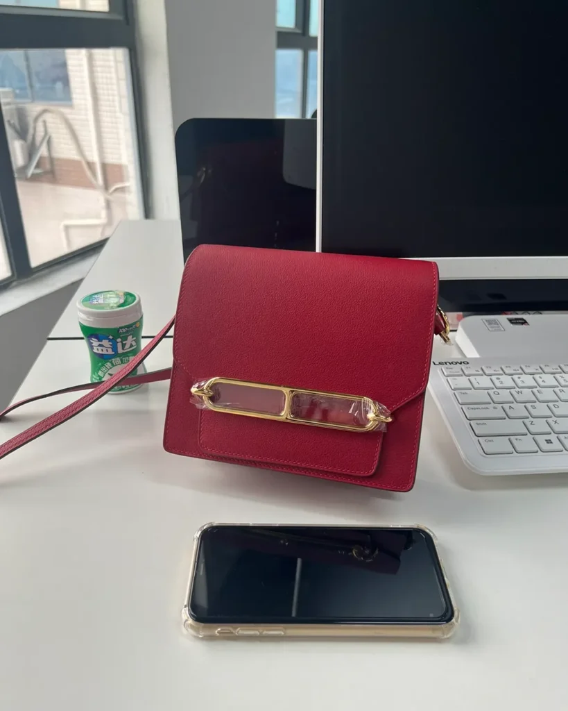 Red roulis-inspired mini bag, front size comparison view