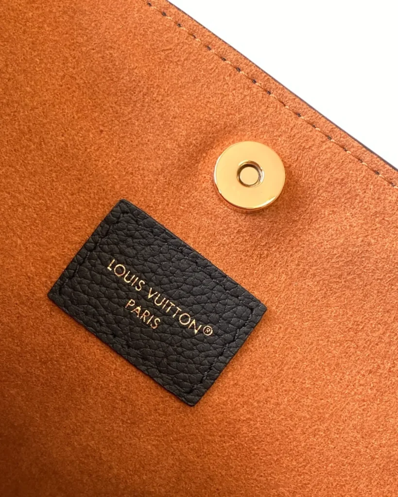 Black Curved Top Bucket Bag with Padlock — interior label view