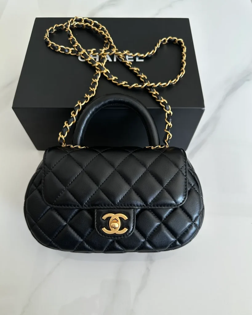 Black Rounded Quilted Top-Handle Bag — front view