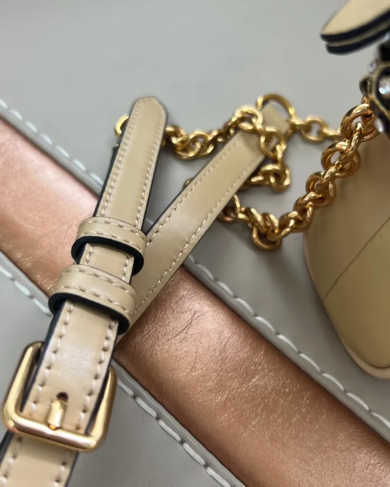Beige Chevron Zip-Top Chain Bag — strap detail view