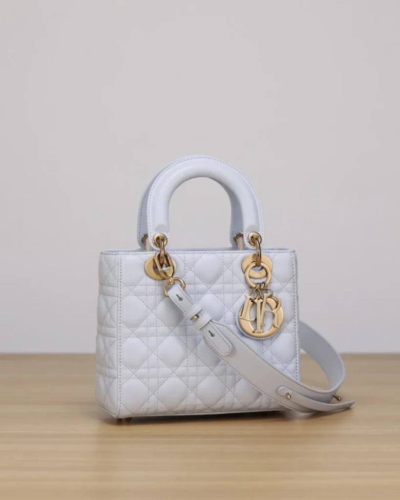 Pale Gray Quilted Top Handle Bag — angled front view