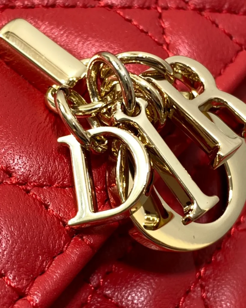 Red Quilted Top Handle Flap Bag — charm detail view