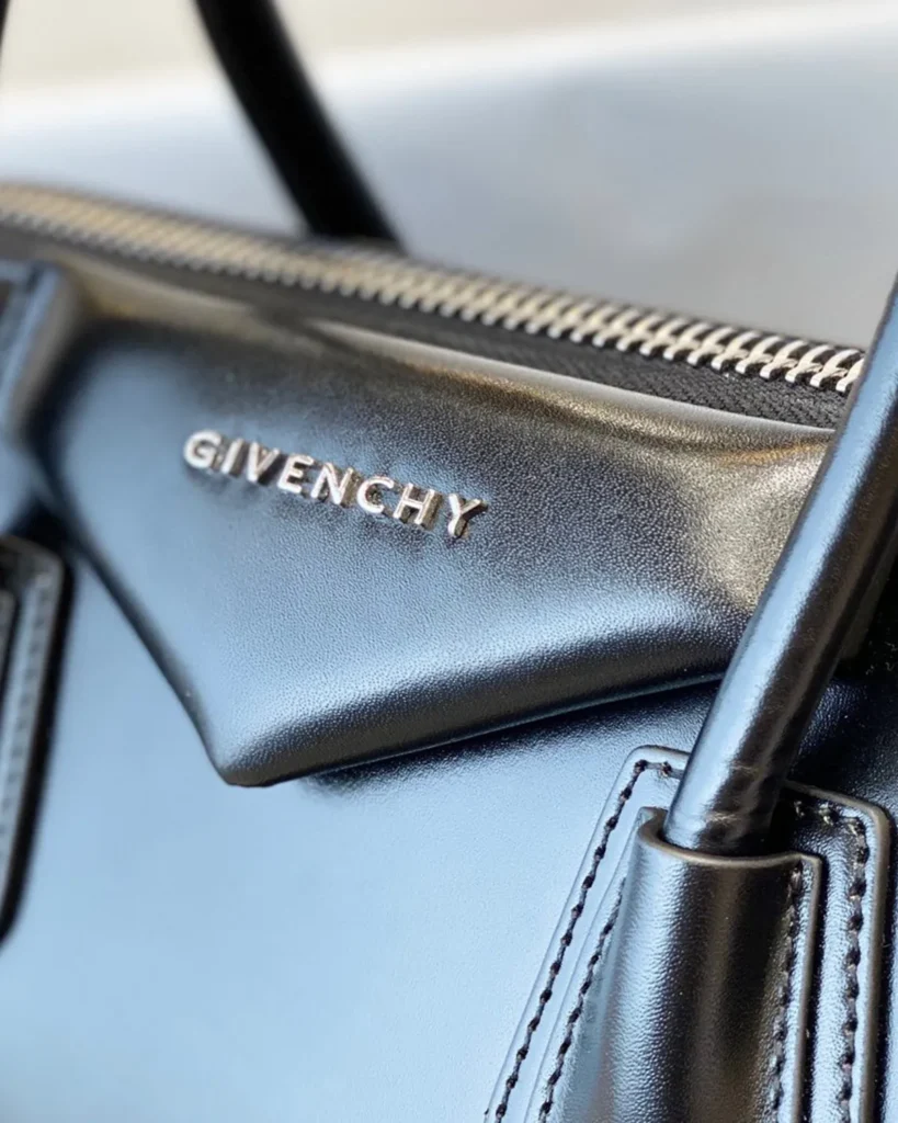 Black Architectural Top Handle Bag — logo detail view