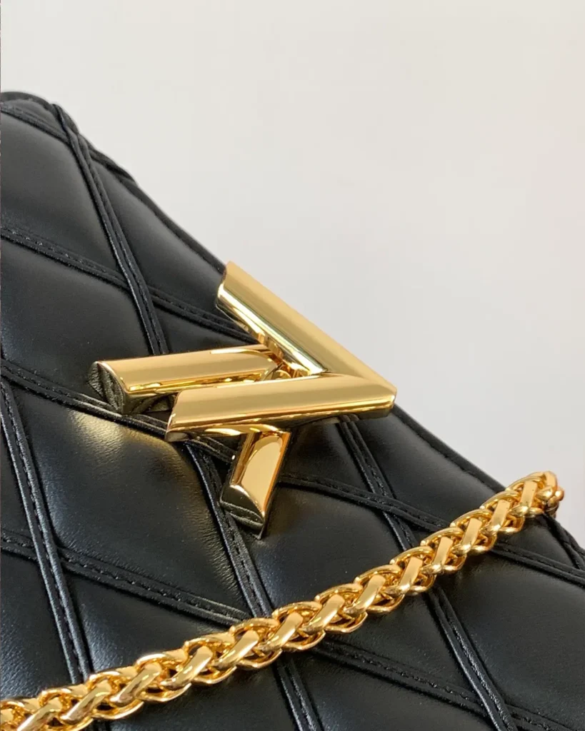 Black Quilted Chain Flap Bag — emblem view