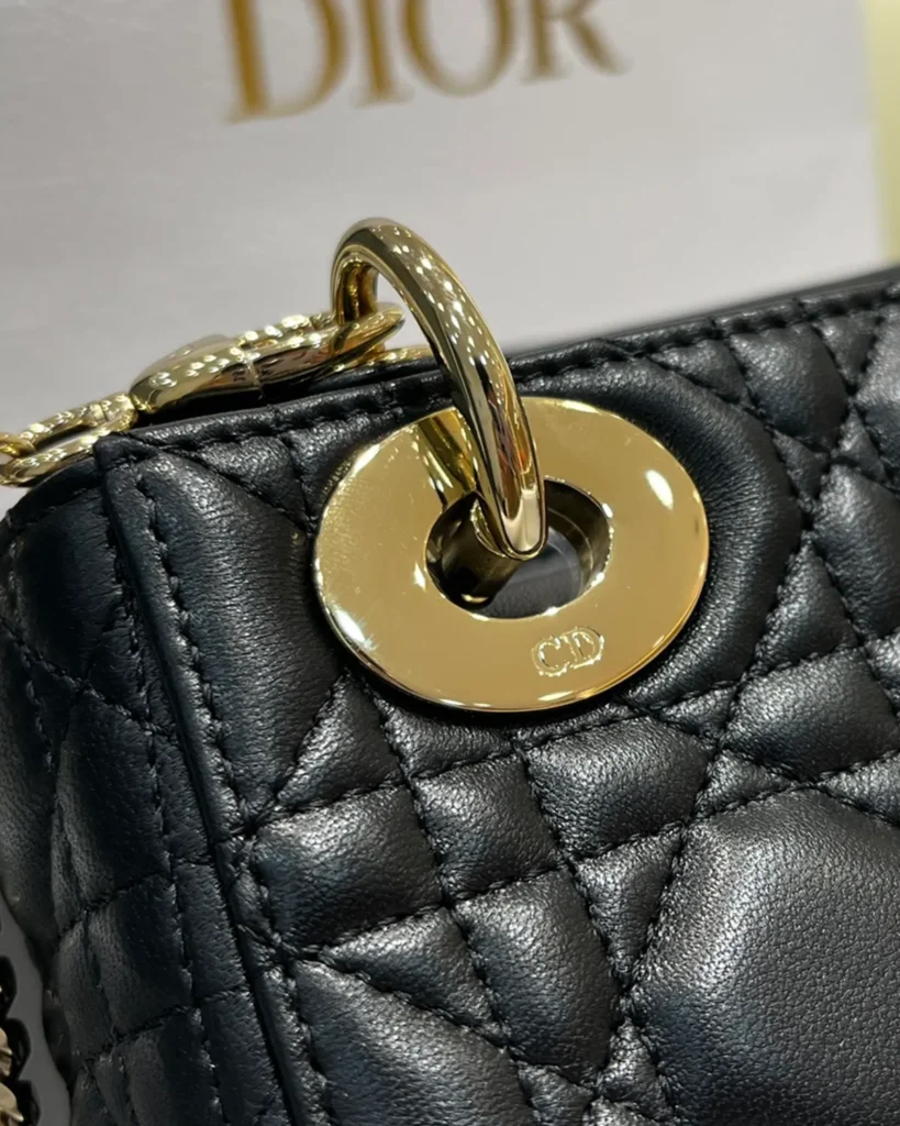 Black Quilted Chain Top Handle Bag — hardware detail view