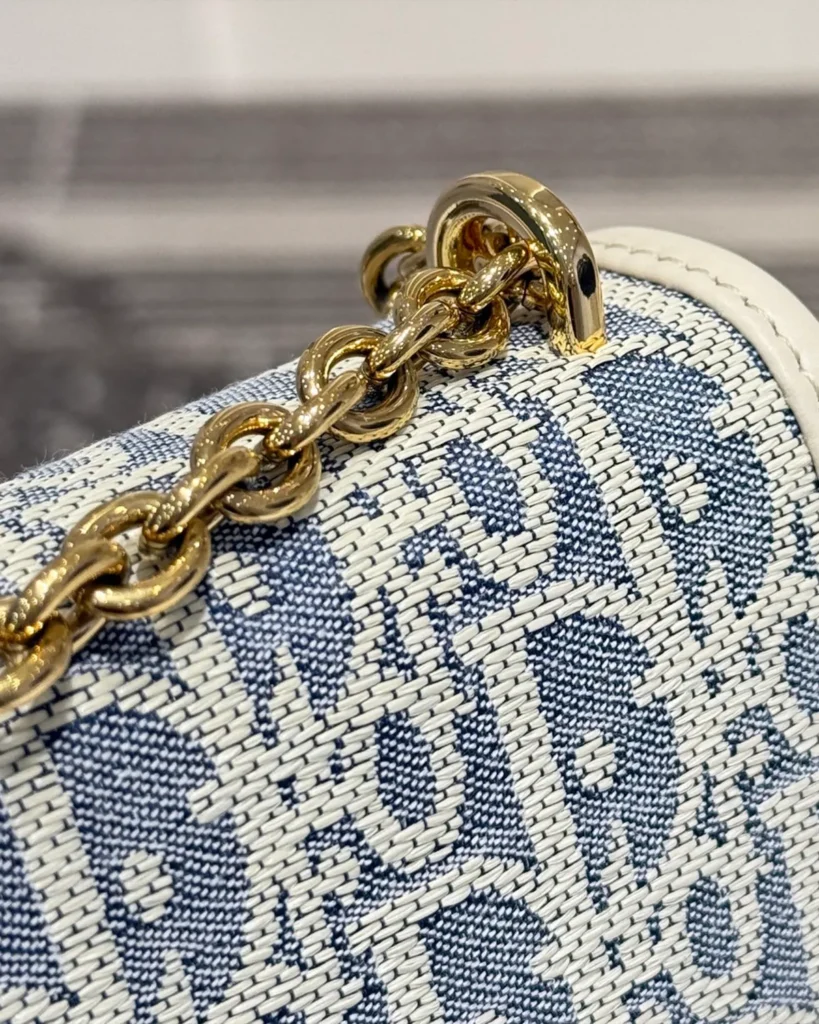 Blue and Cream Patterned Flap Bag — chain eyelet view