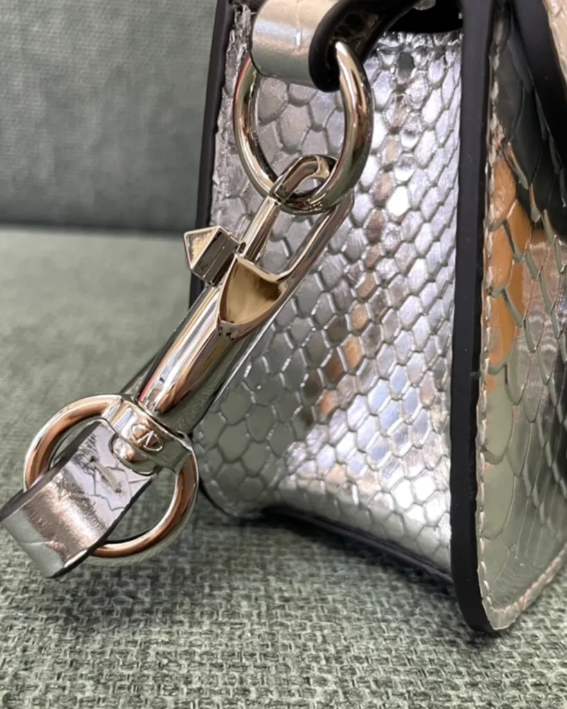 Silver Scale-Pattern Top-Handle Flap Bag — strap clip view
