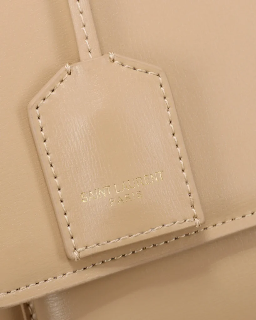 Beige Accordion Chain Flap Bag — tag detail view