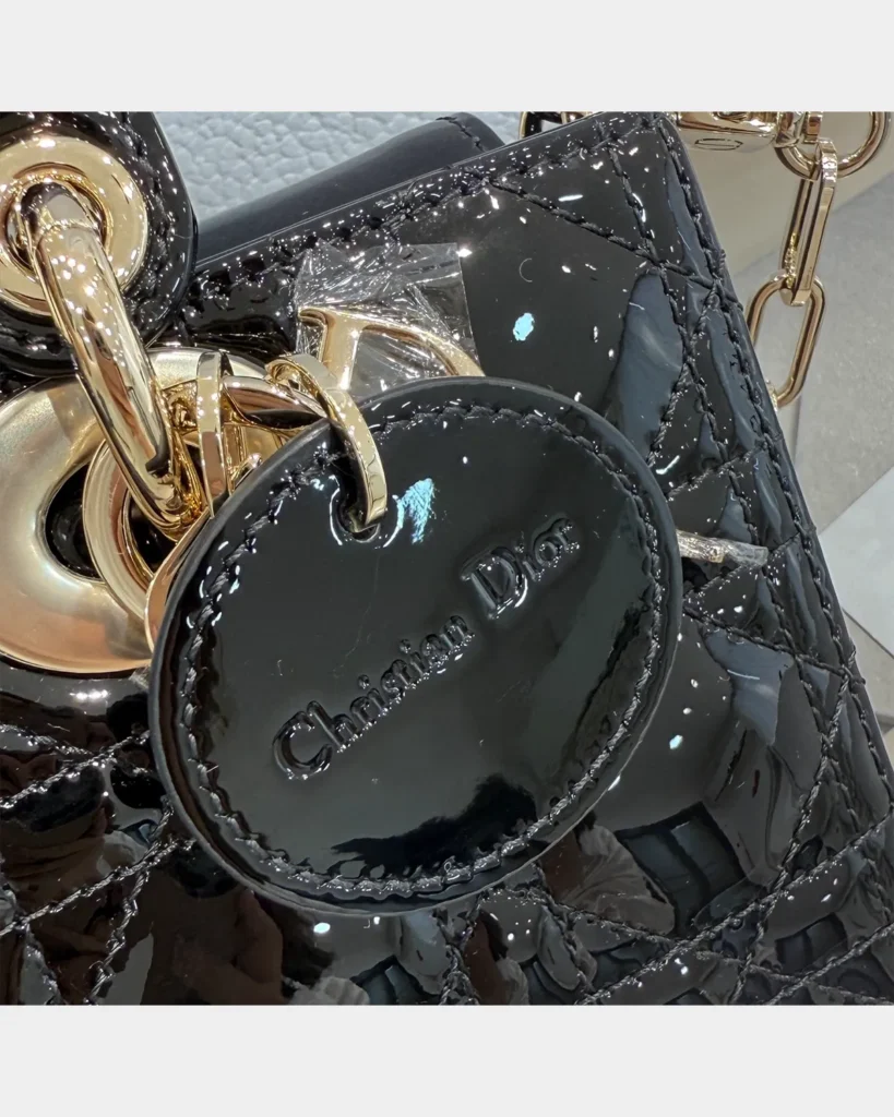 Glossy Black Horizontal Quilted Handbag — tag detail view