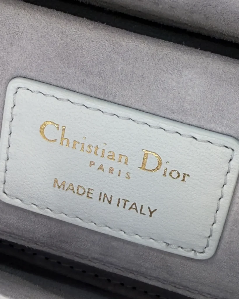 Pale Blue Horizontal Quilted Top Handle Bag — interior label view