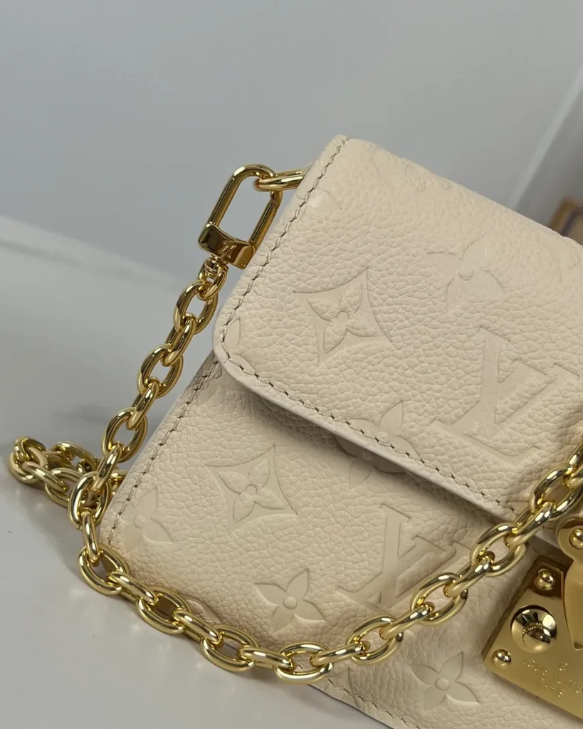 Cream Embossed Flap Chain Wallet — chain detail view