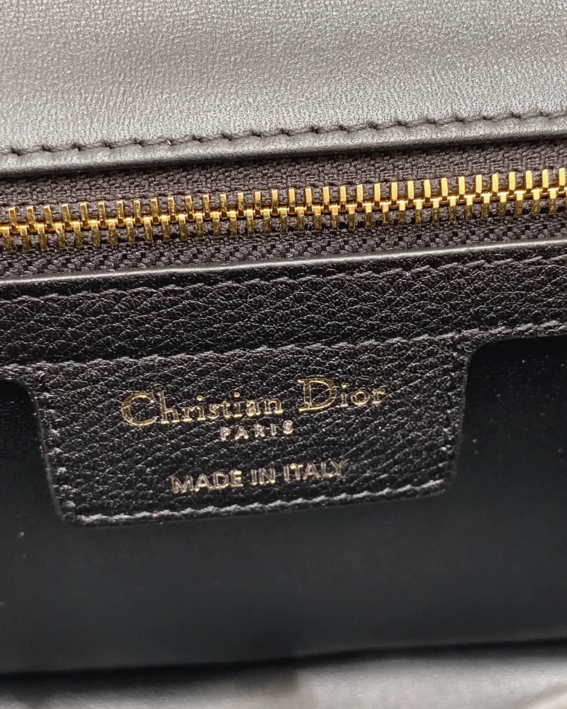 Black Quilted Flap Bag with Gold Tone Clasp — interior zipper view