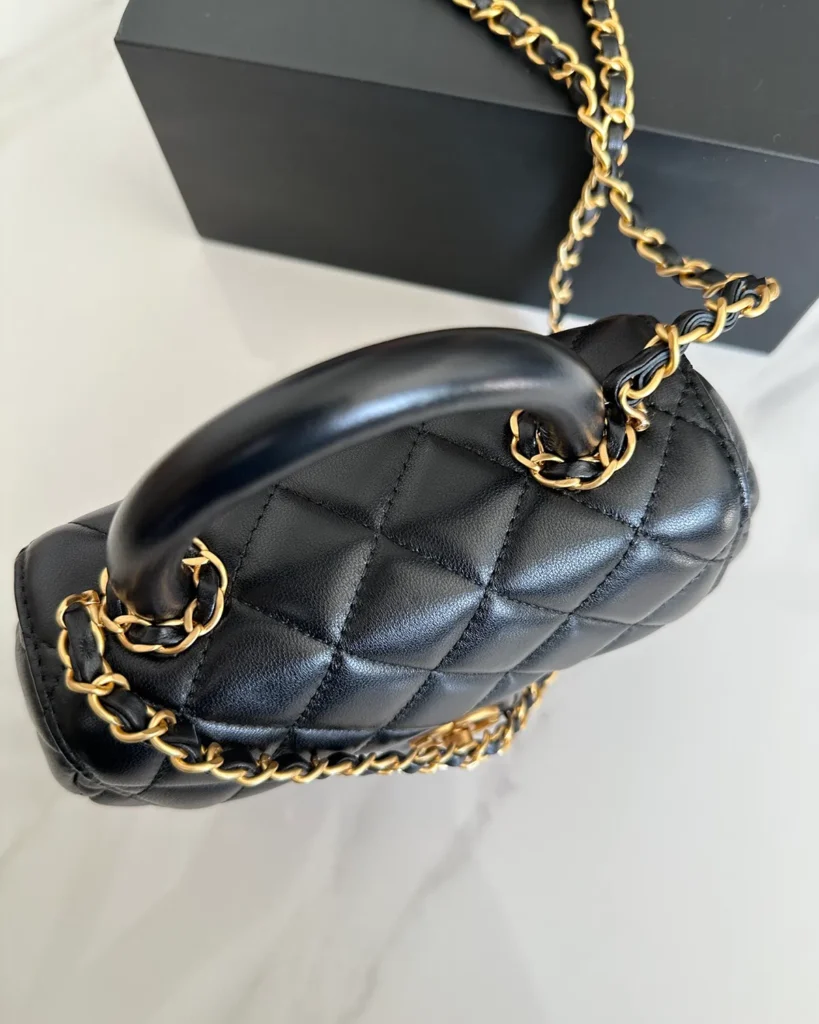 Black Rounded Quilted Top-Handle Bag — top view