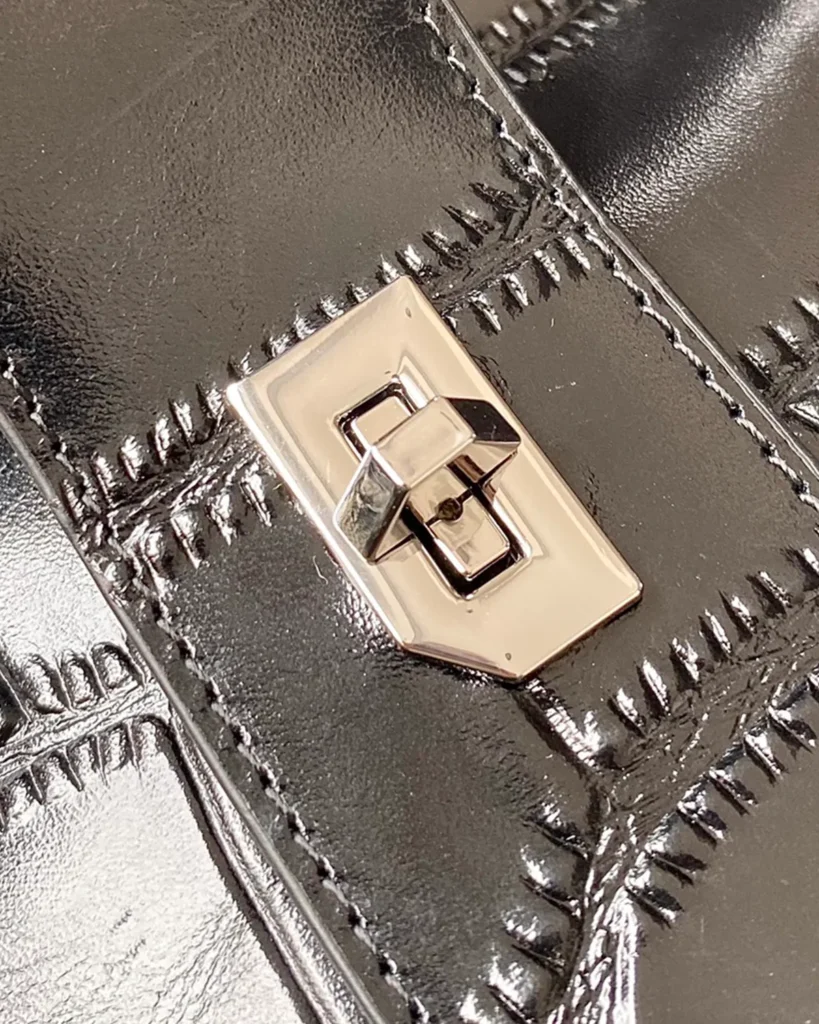 Black Scale-Pattern Padlock Handbag — turn lock detail