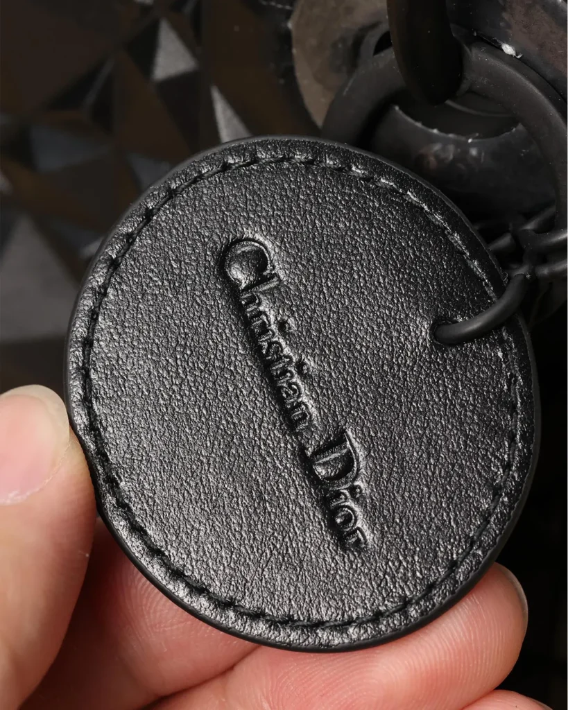 Black Faceted Top Handle Bag — tag detail view