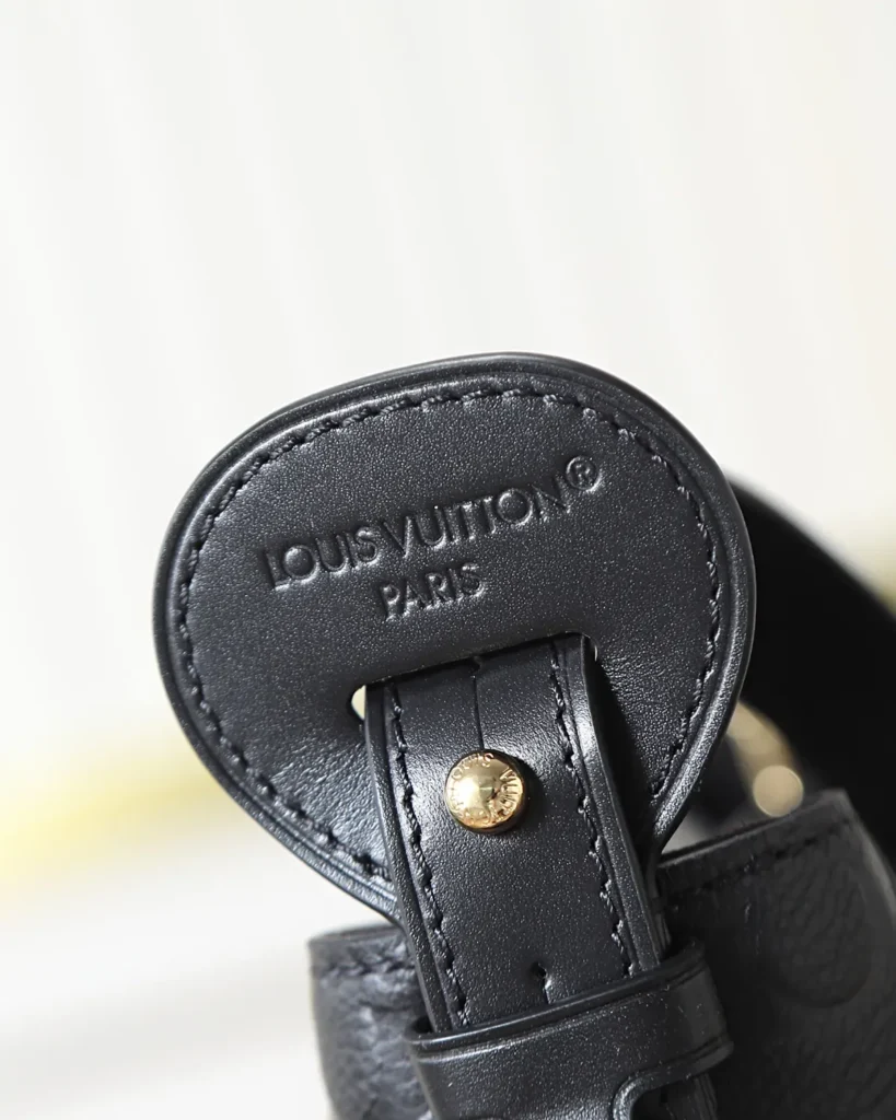 Black Embossed Monogram Bucket Bag — handle detail view
