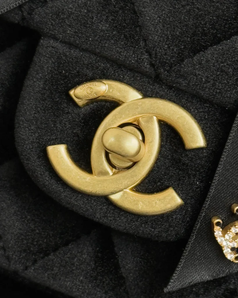 Black Bow-Detail Quilted Top-Handle Bag — logo detail view