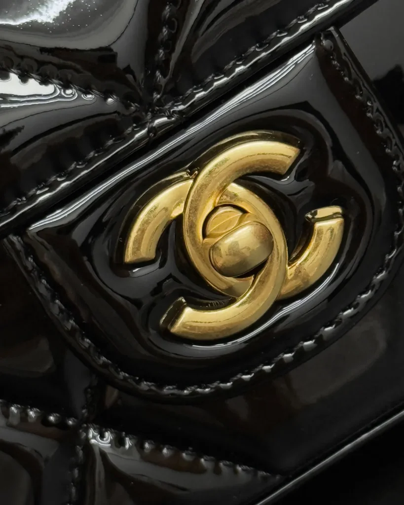 Glossy Black Quilted Handle Clutch — clasp detail view