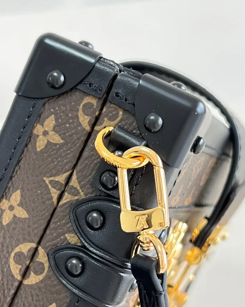 Brown Monogram Black-Trim Trunk Bag — strap clip view