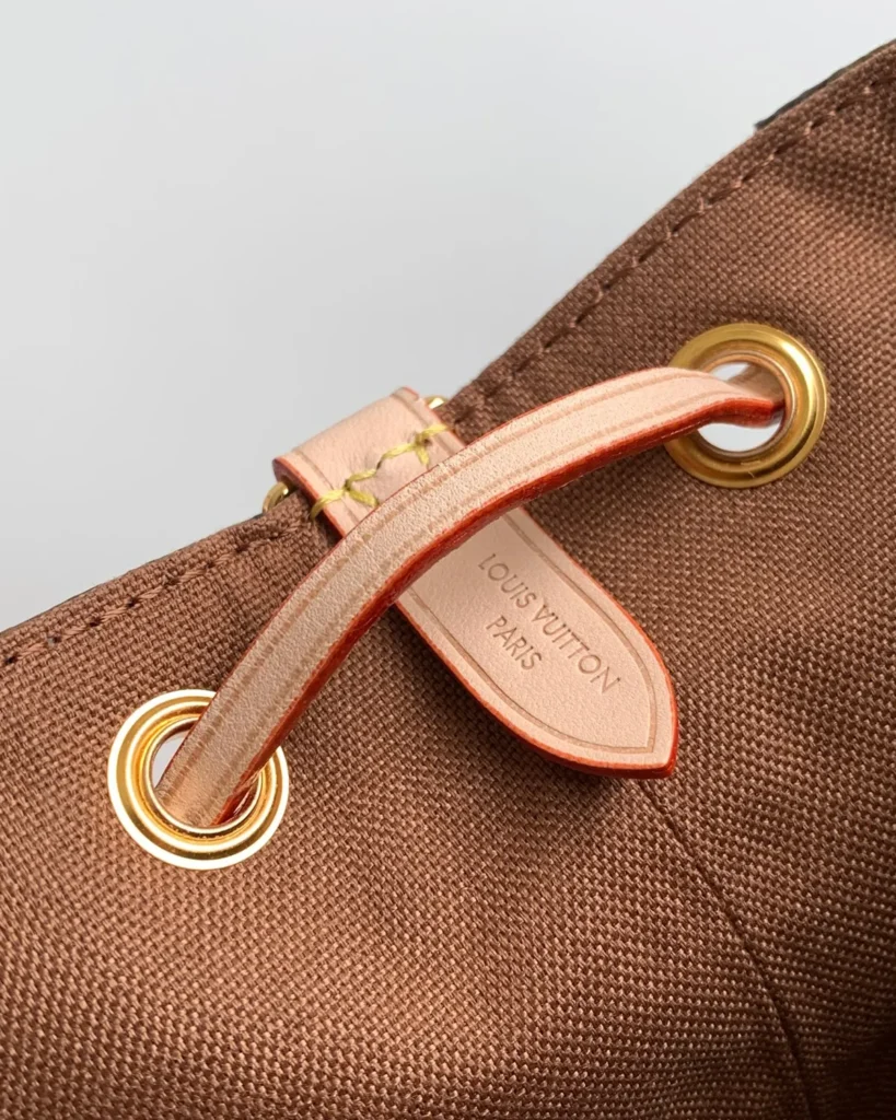 Brown Monogram Buckled Flap Satchel — drawstring detail view