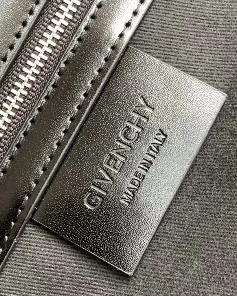 Black Geometric Embossed Twin-Handle Satchel — label detail