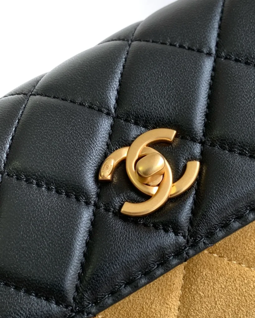 Tan and Black Quilted Flap Shoulder Bag — clasp detail view
