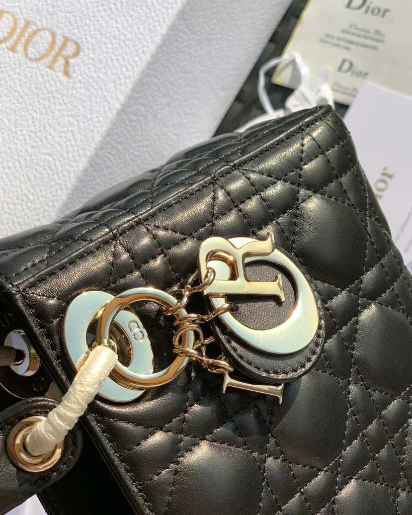 Black Quilted Compact Top Handle Bag — hardware detail view