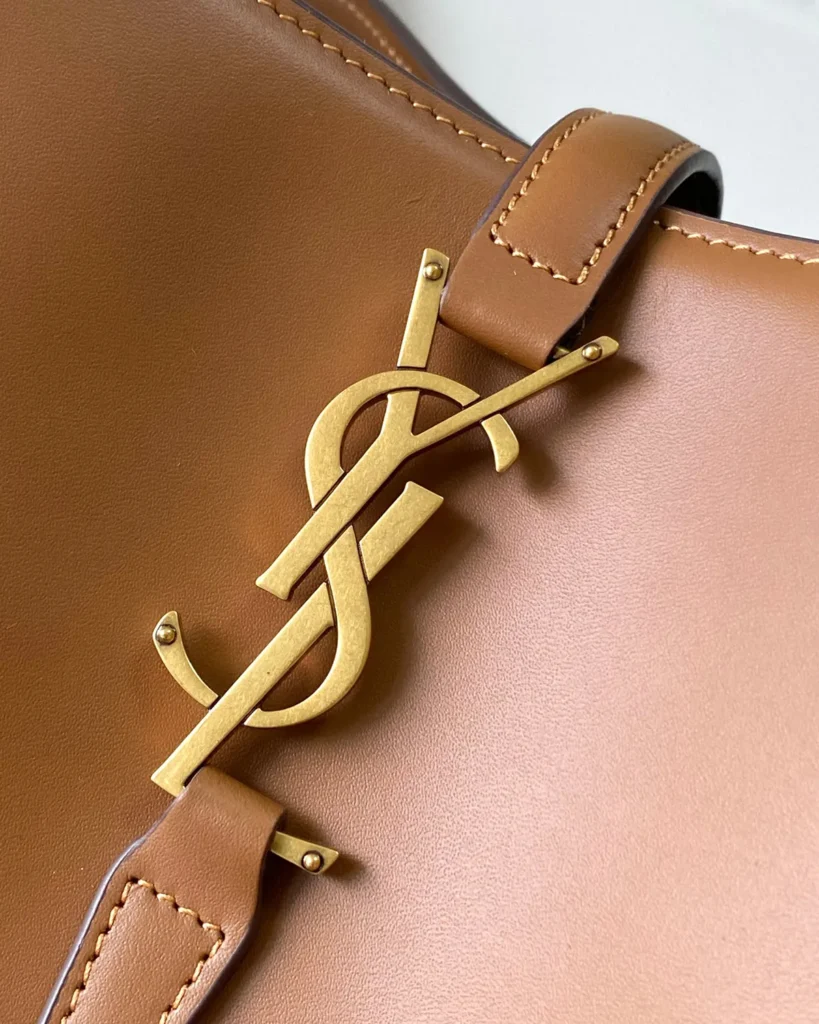 Tan Curved-Top Bucket Bag — logo detail view
