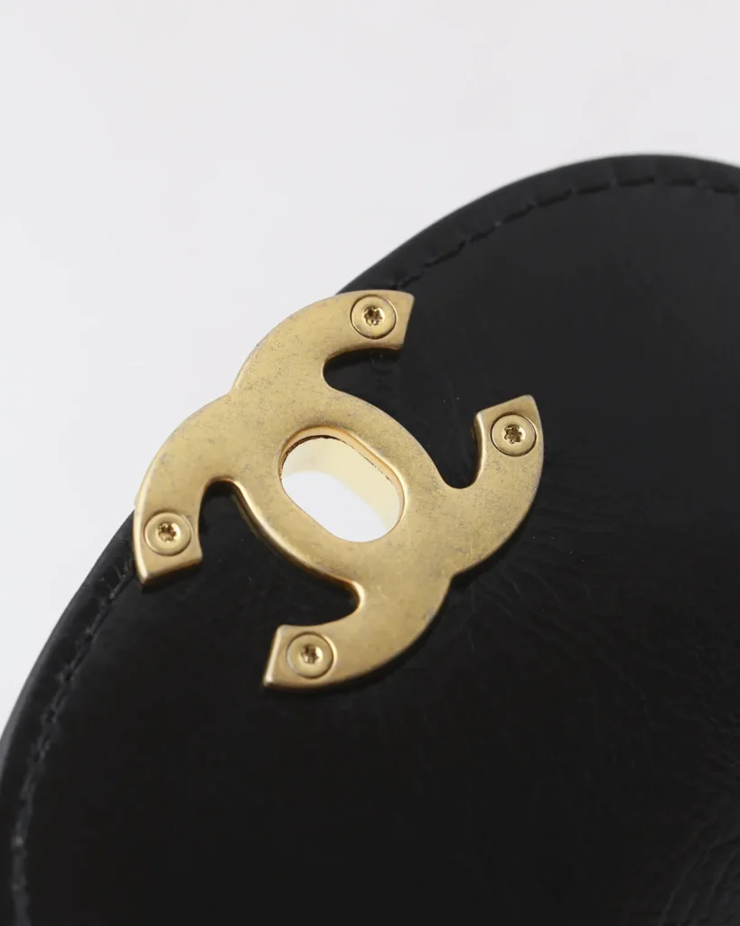 Black Quilted Tab-Flap Top-Handle Bag — clasp back view