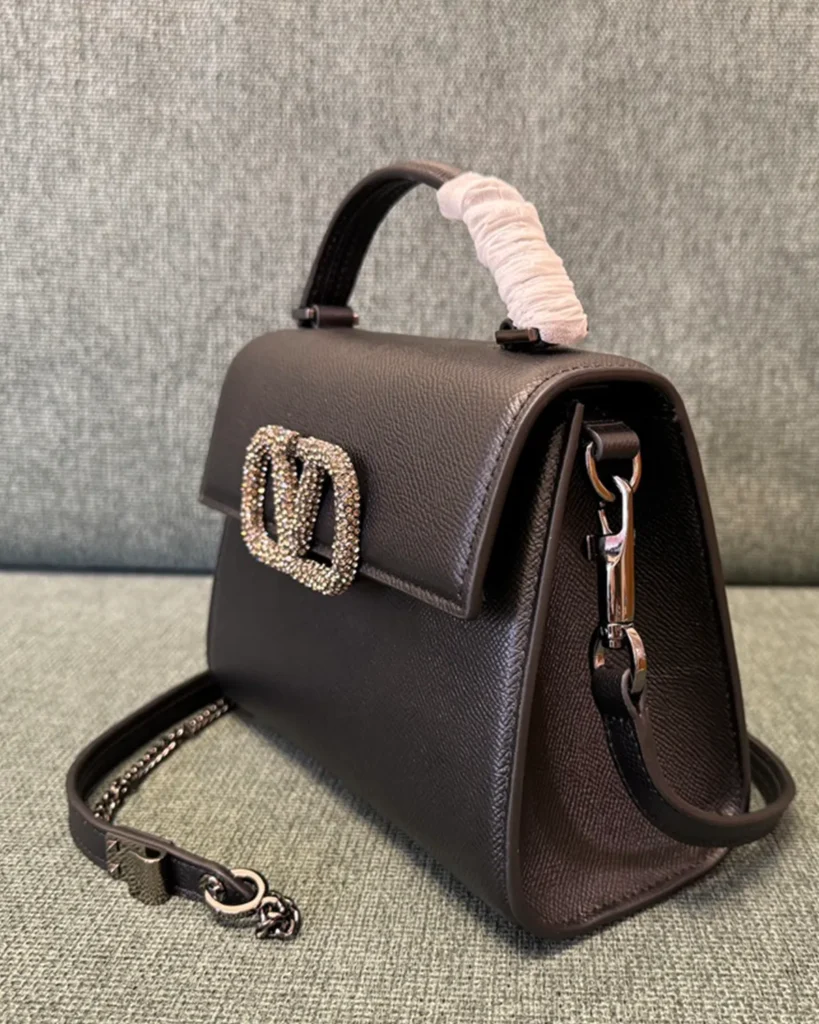 Dark Brown Embellished Emblem Top-Handle Bag — angled front view