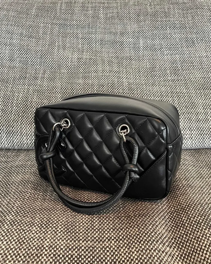 Black Quilted Offset-Emblem Bowler Bag — top view