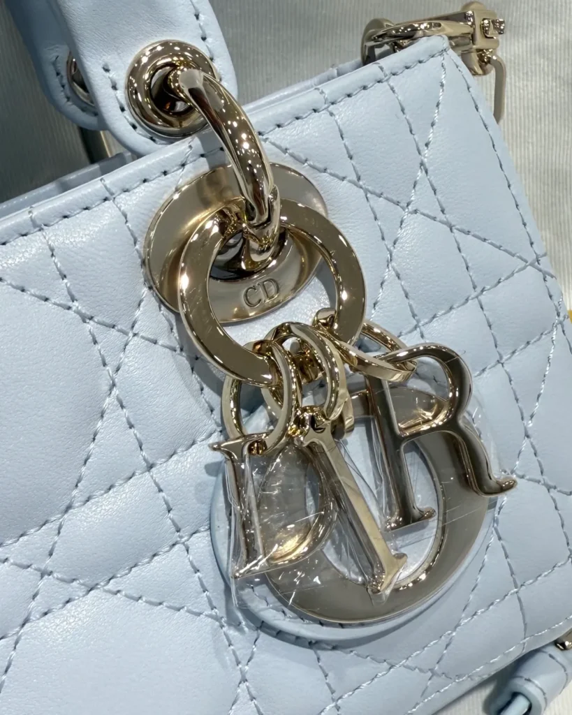 Soft Blue Quilted Chain Handbag — charm detail view