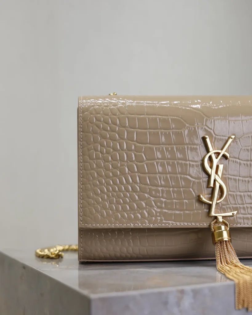 Taupe Embossed Tassel Chain Bag — logo detail view