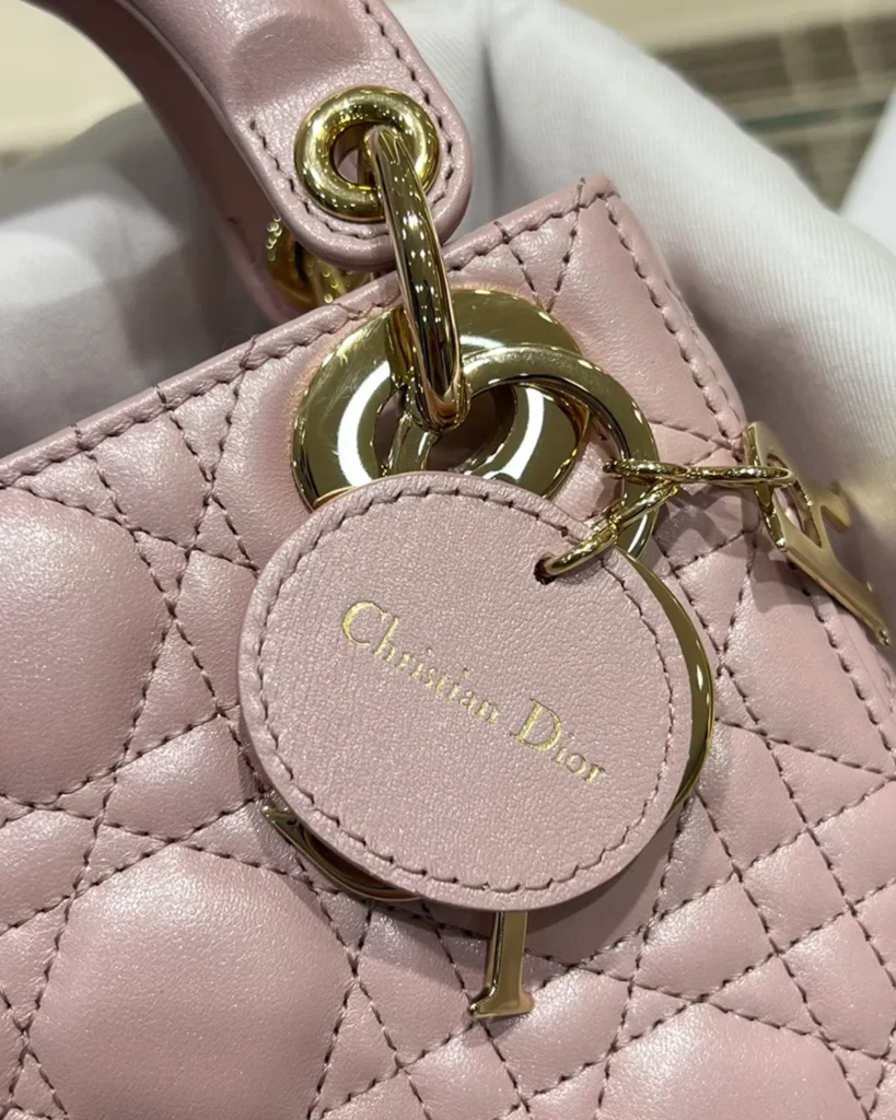 Pearlescent Pink Quilted Top Handle Bag — round tag view