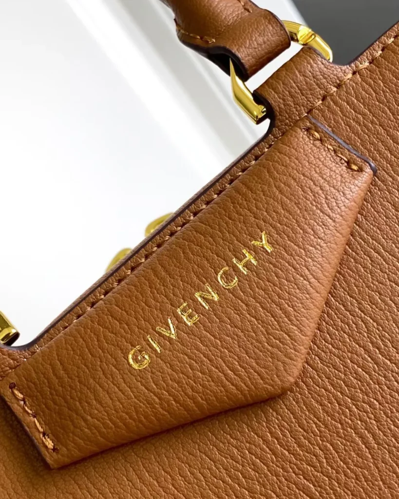 Tan Domed Top Handle Bag — logo detail view