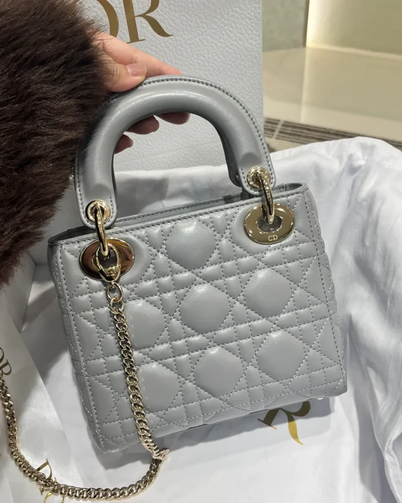 Pearlescent Gray Quilted Top Handle Bag — angled front view