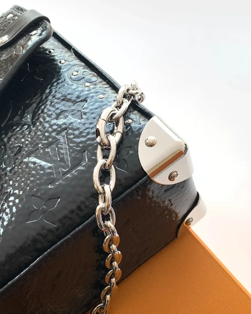 Black Embossed Chain Flap Bag — corner detail view
