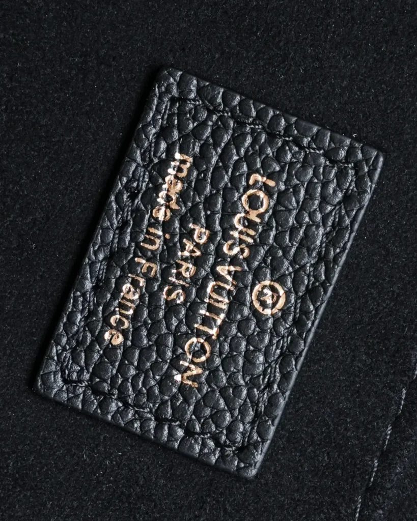 Black Embossed Flap Top Handle Bag — interior label view