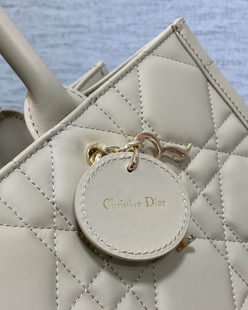 Taupe Geometric Quilted Tote — tag detail view
