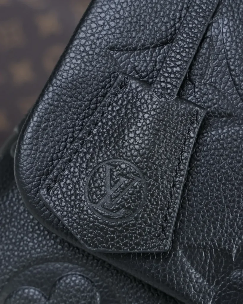 Black Embossed Flap Top Handle Bag — tag detail view