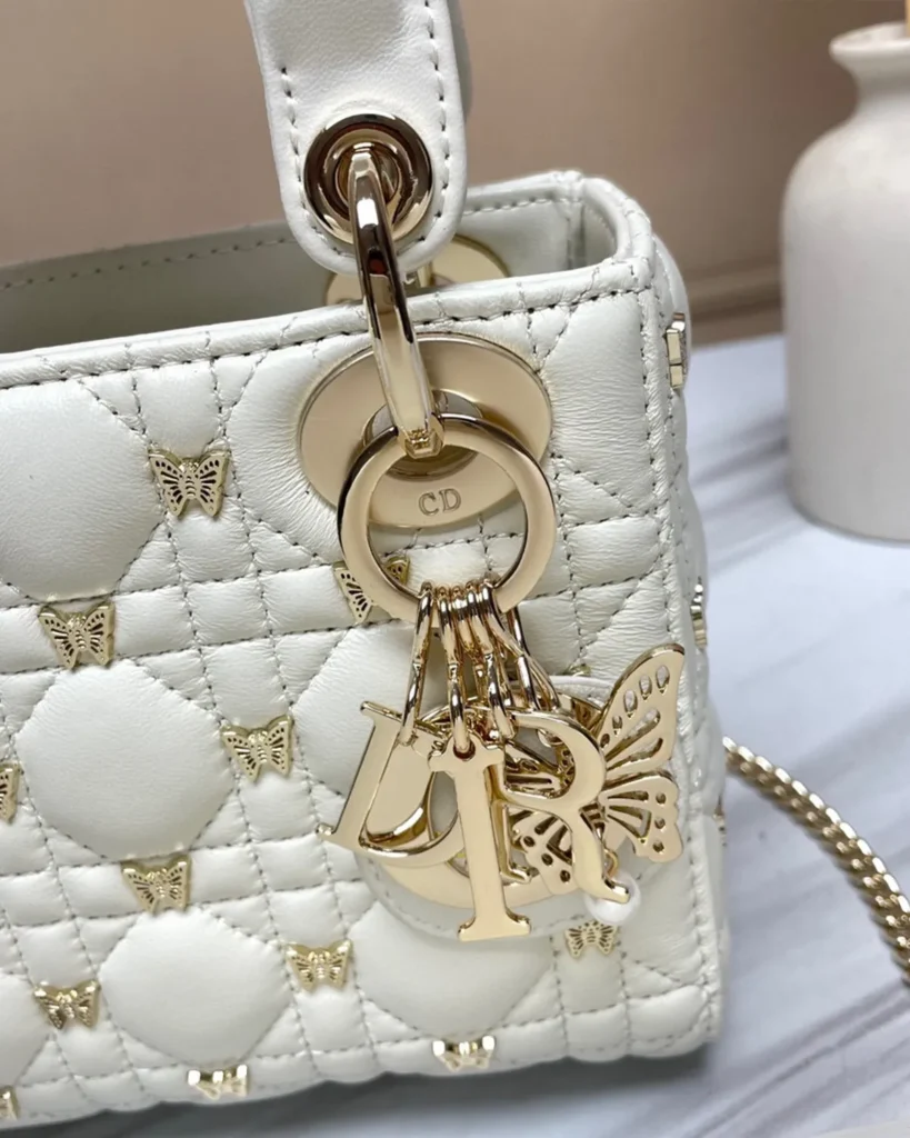 Ivory Butterfly Stud Quilted Top Handle Bag — charms view