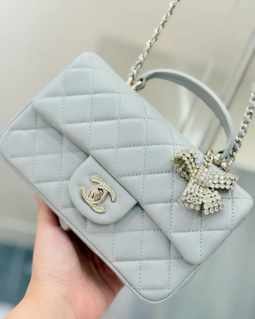 Pale Grey Quilted Top-Handle Flap Bag — angled front view