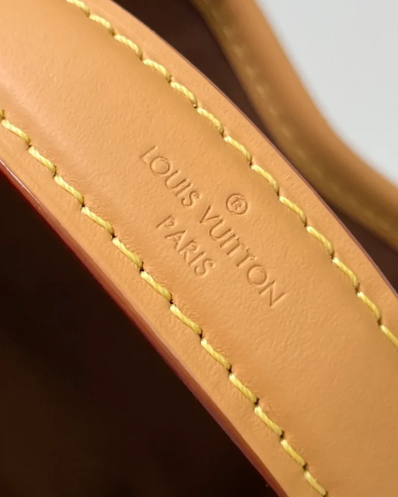 Brown Monogram Tan-Trim Drawstring Bucket Bag — handle detail view
