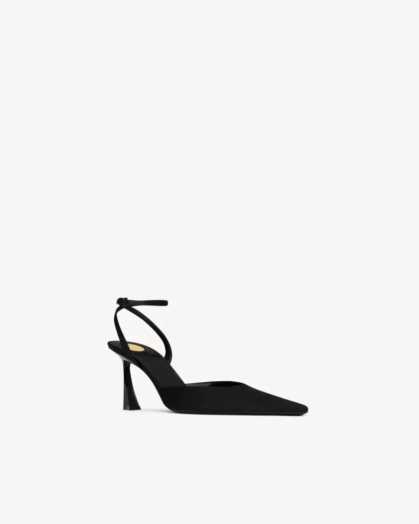 Angled side view of a black pointed-toe slingback pump with a sculpted heel