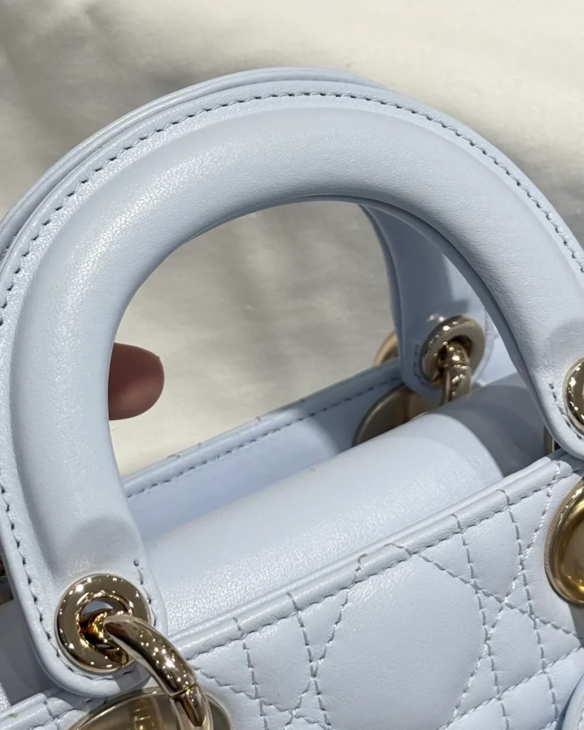 Pale Blue Horizontal Quilted Top Handle Bag — handle detail view